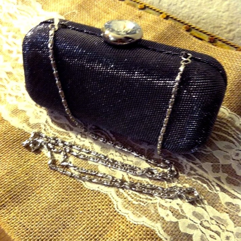 Black shimmery clutch with large diamond clasp